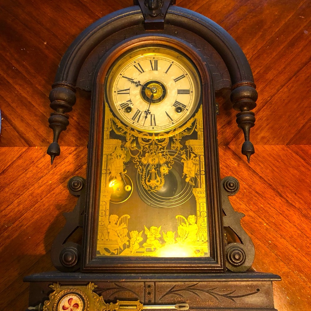 Antique wooden carved clock with winding key